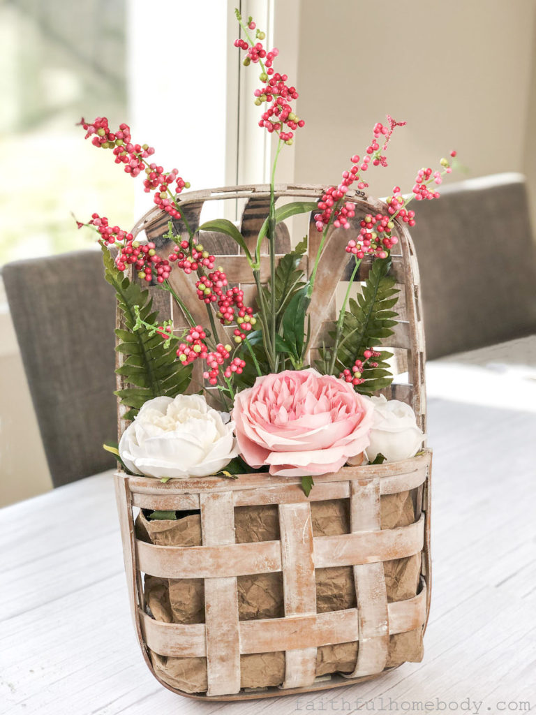 How to Make a Hanging Tobacco Basket for Valentine's Day.  Basket is displayed.  Pink and white peonies with pink, red, and white berry stem and fern leaves.  